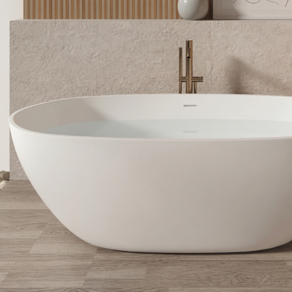 Bañera exenta de superficie sólida con formas redondeadas y diseño minimalista
