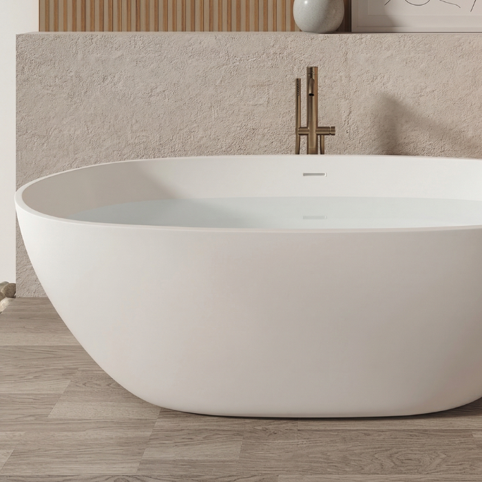 Bañera exenta de superficie sólida con formas redondeadas y diseño minimalista
